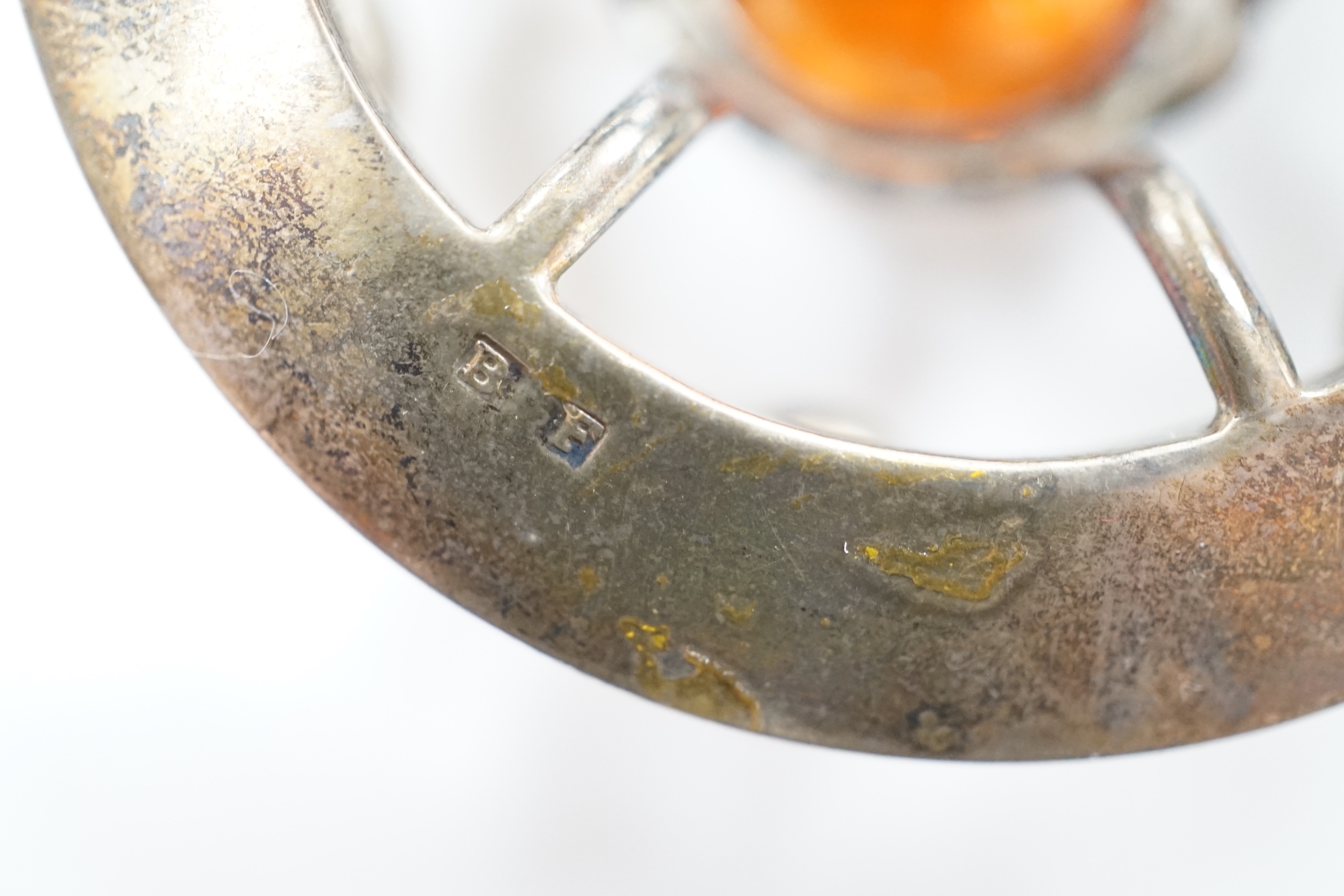 A white metal and multi gem set openwork circular brooch, with central dark citrine, diameter 49mm.